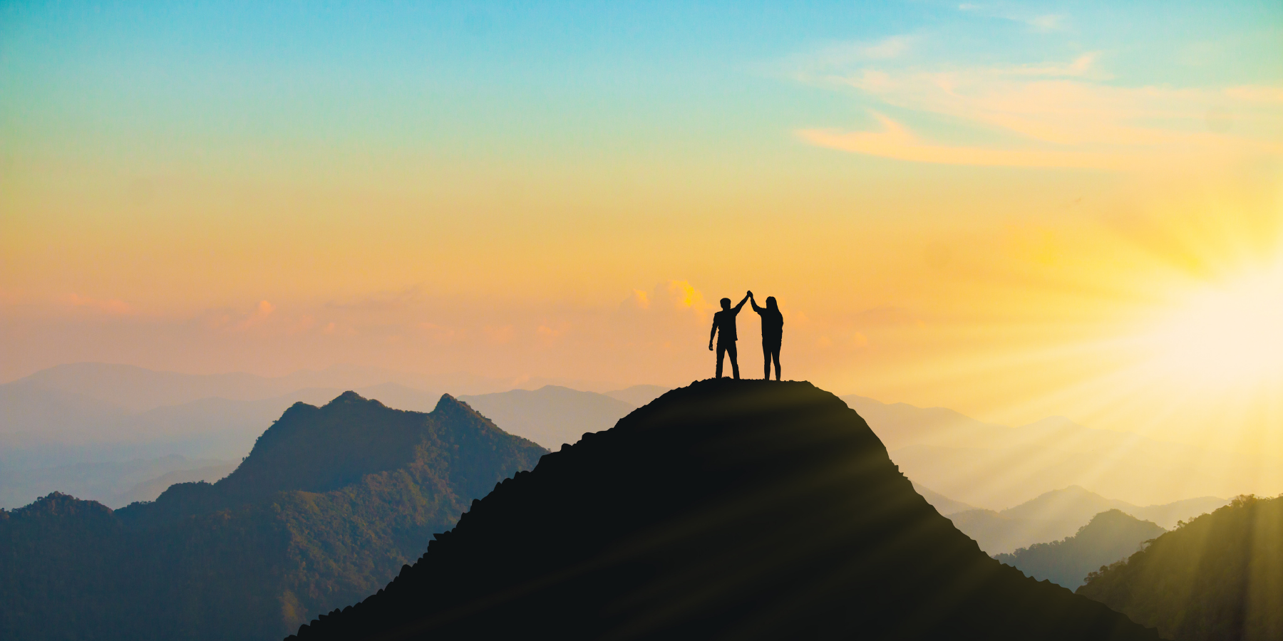Two people on top of a mountain