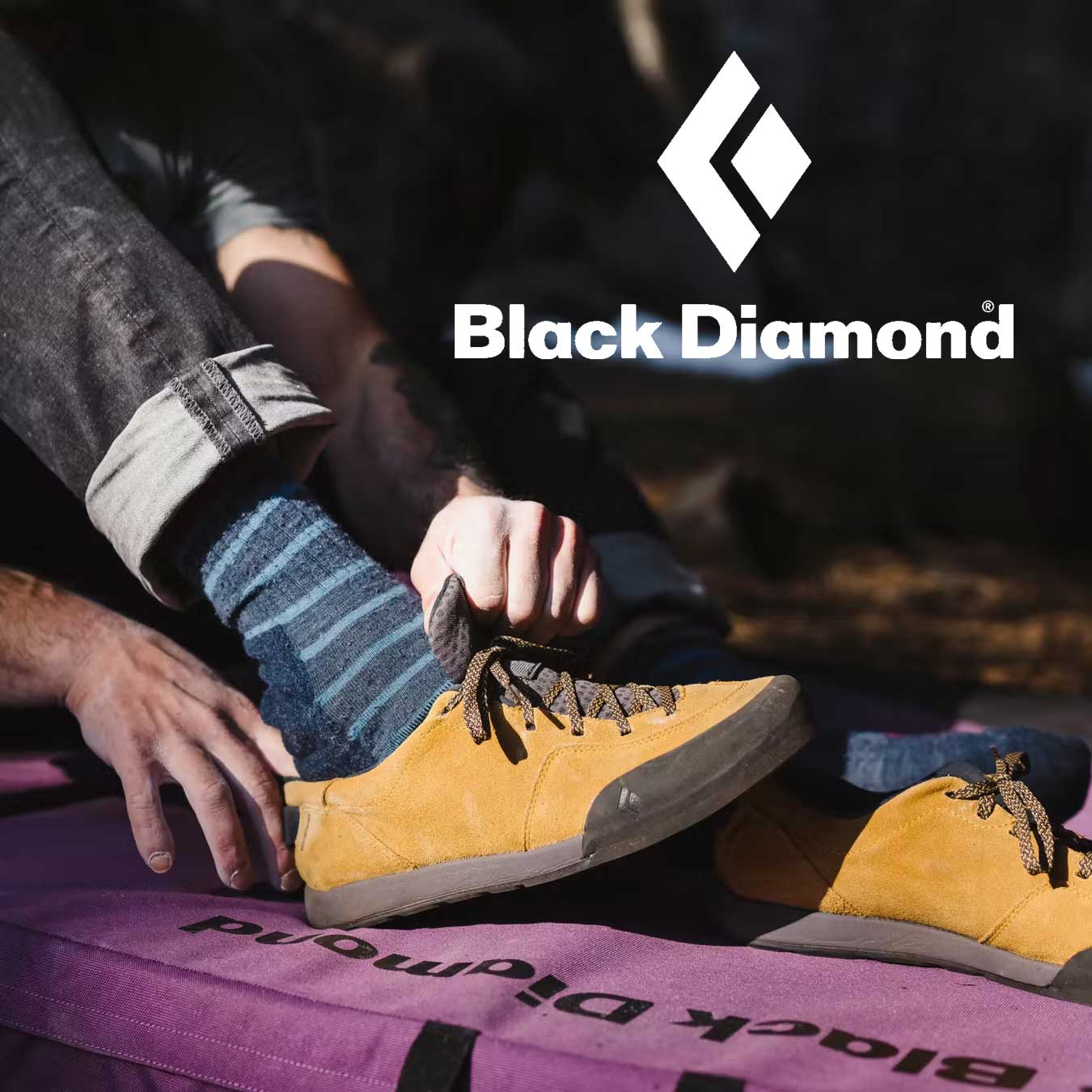 Person putting on rock climbing approach shoes with Black Diamond logo