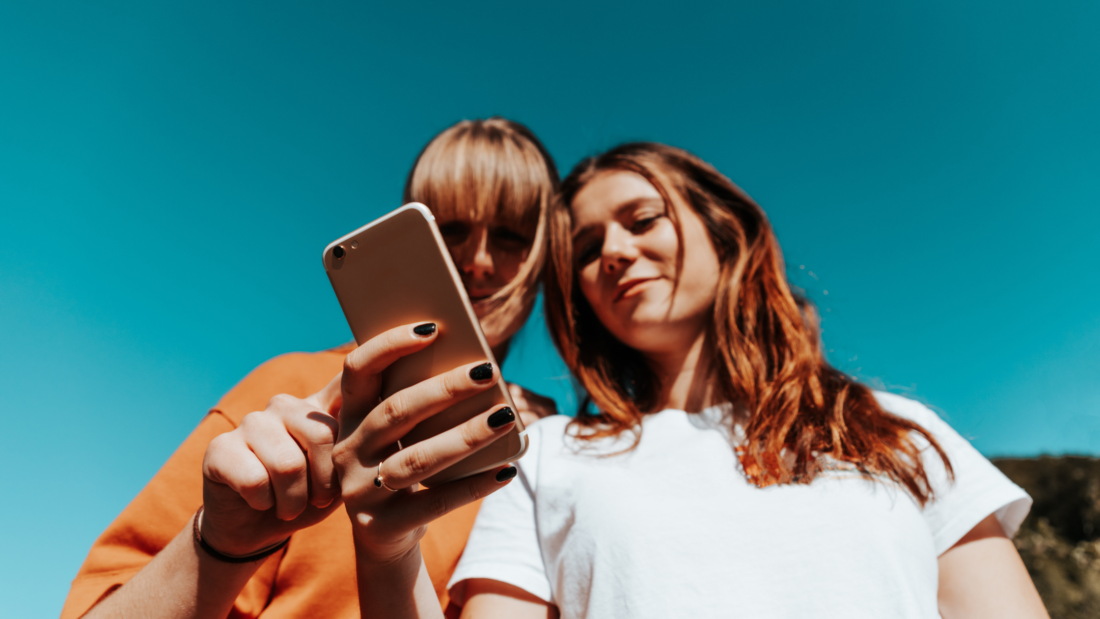 Two women looking at a cell phone