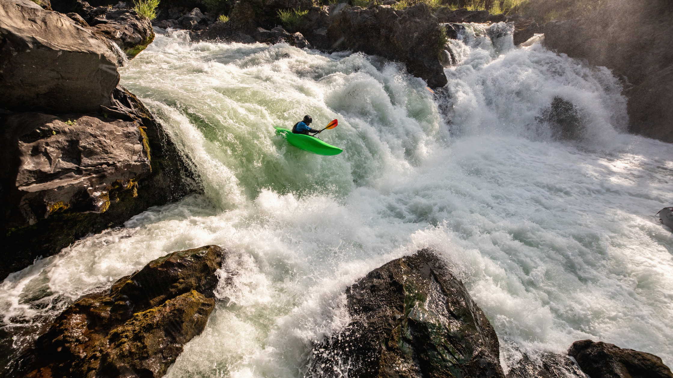 Kayaker going down a waterfall