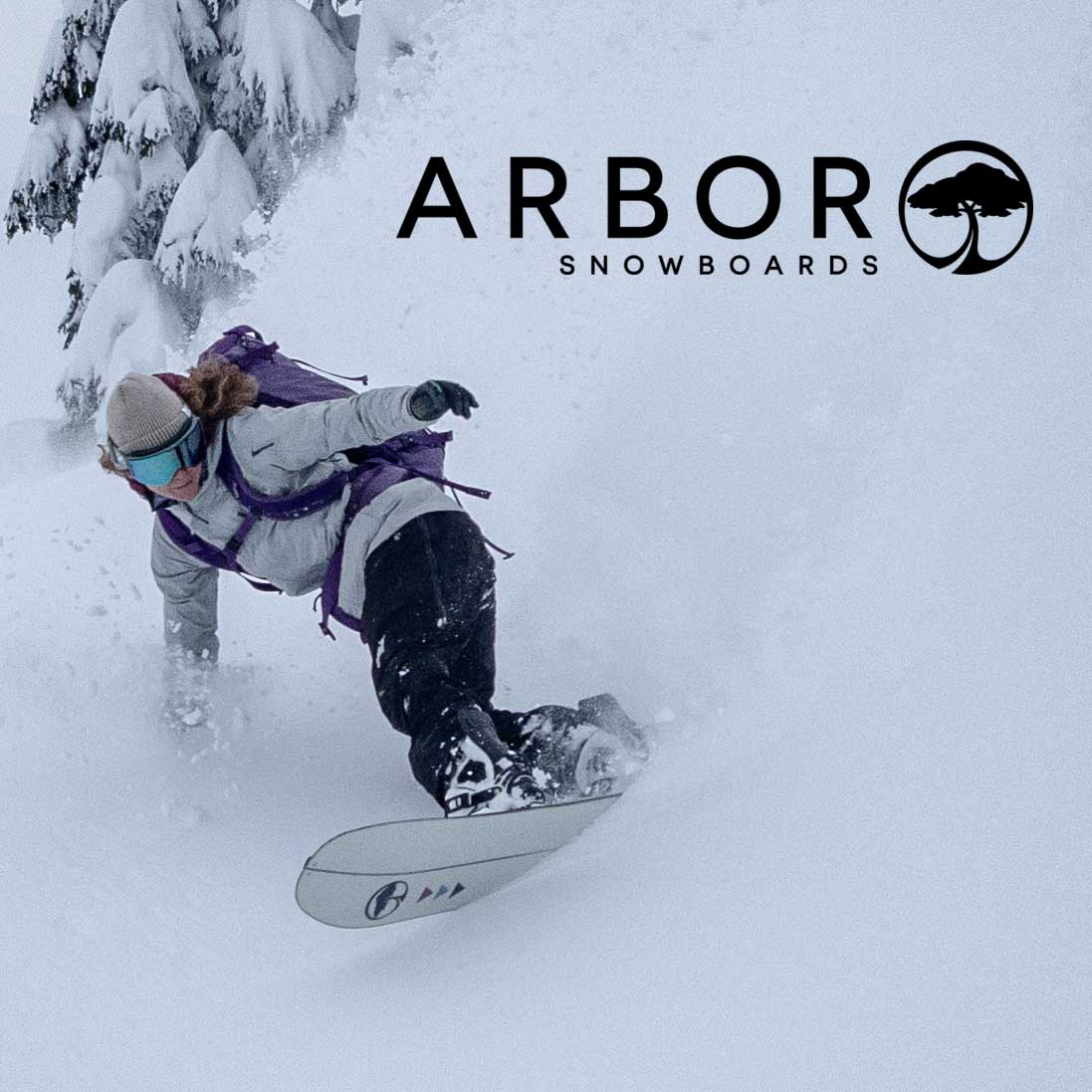 Person snowboarding with Arbor Snowboards logo