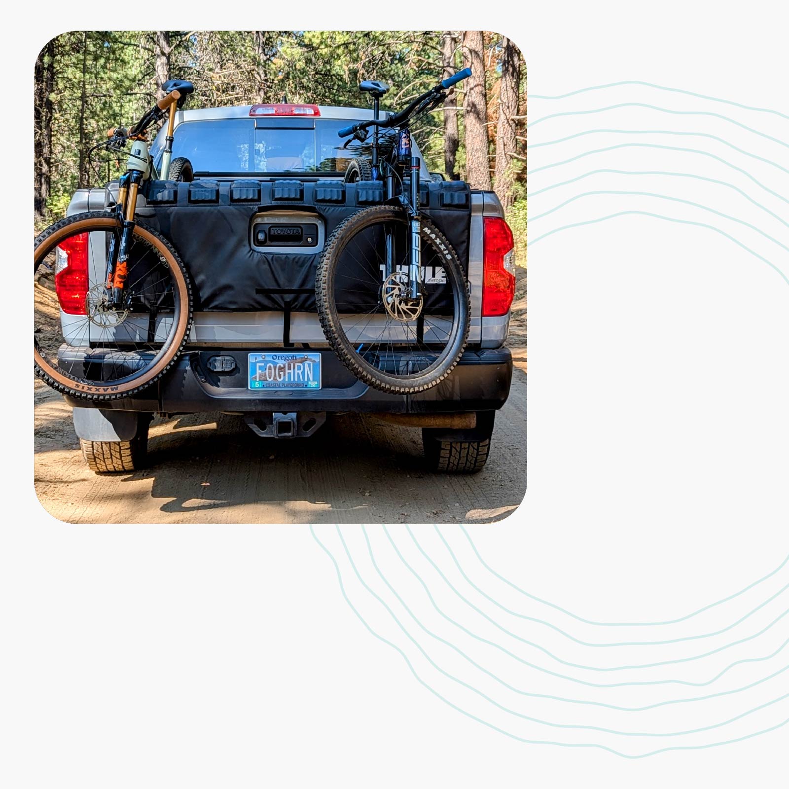 Mountain bikes loaded in the back of a truck