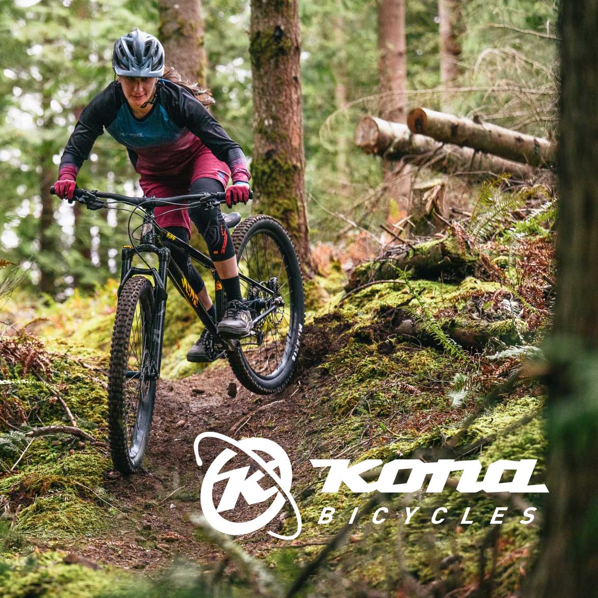 Woman mountain biking with Kona Bicycles logo