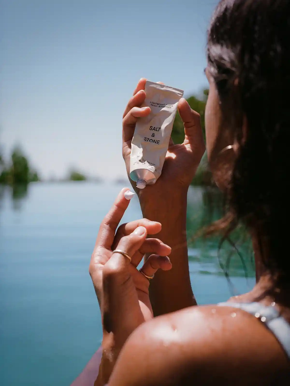 Woman putting on sunscreen